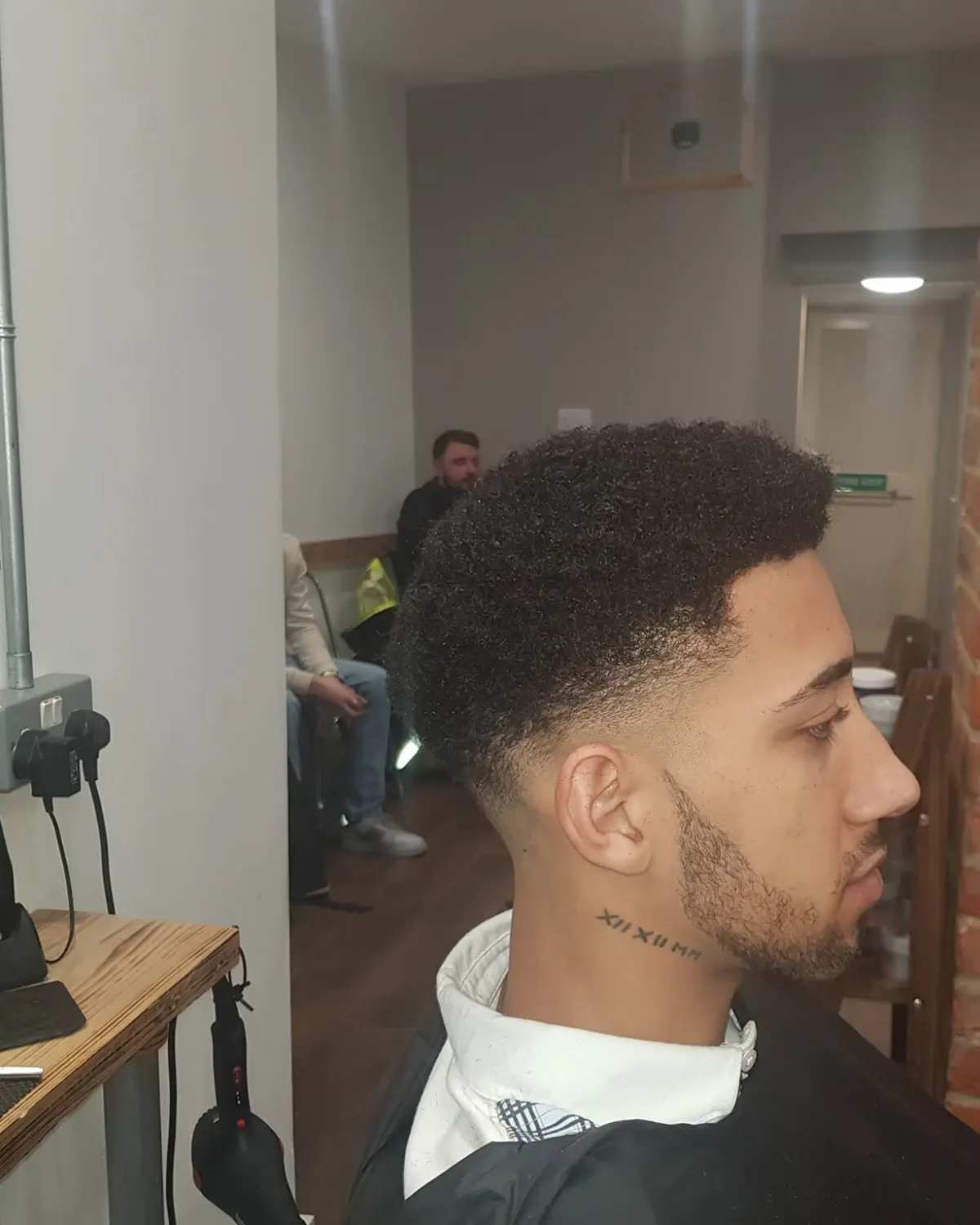 Afro-textured cut with a temple fade and shaped beard, cut at Primo Hair Lounge Ipswich