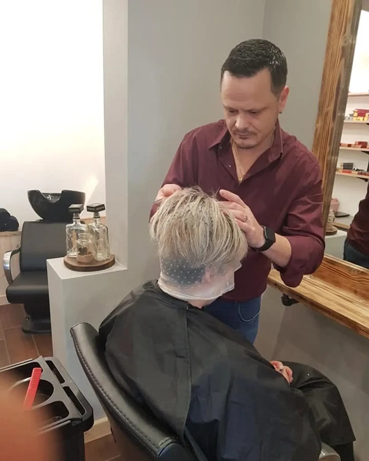 Short blonde crop being styled after a highlight service at Primo Hair Lounge