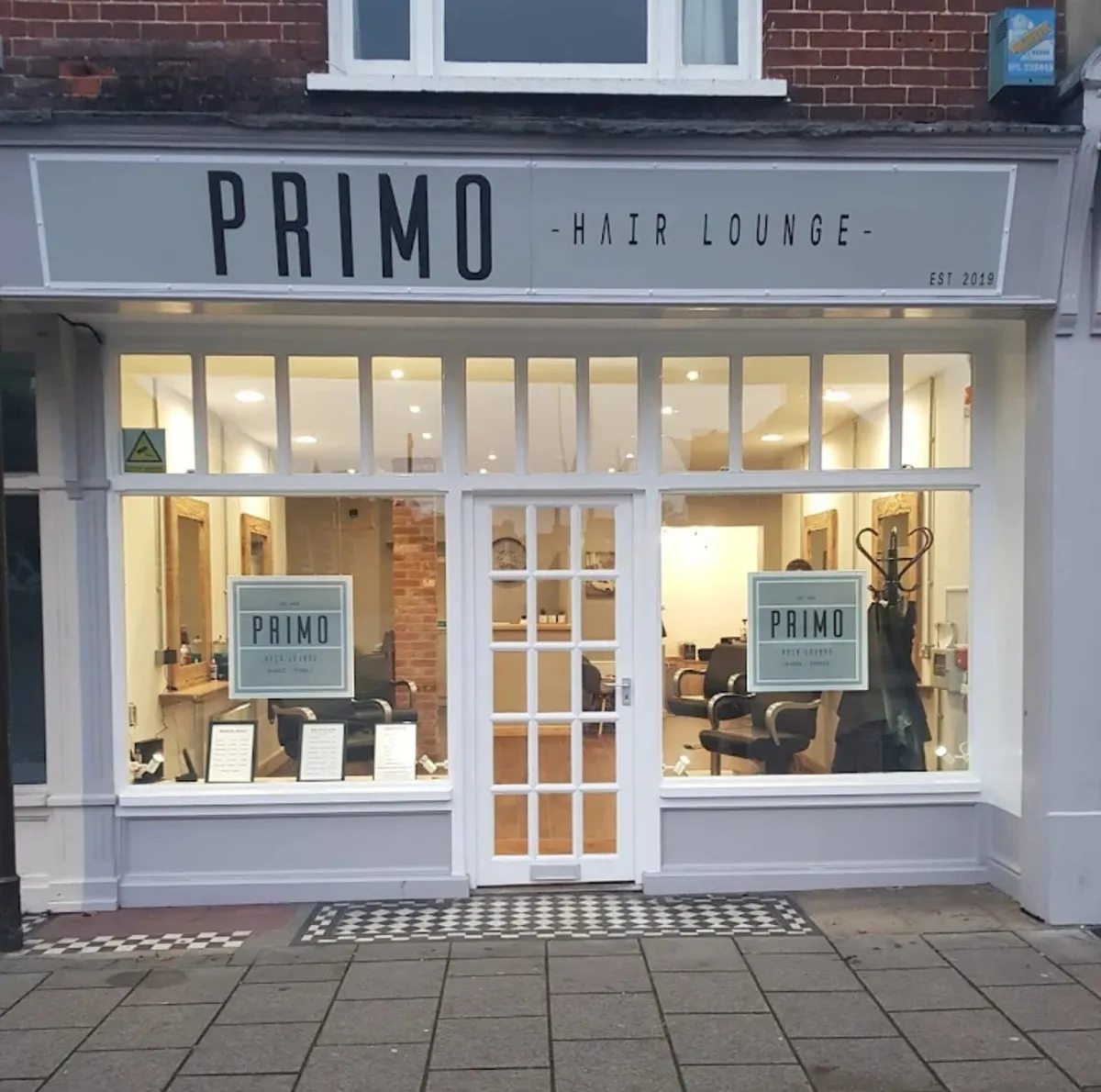 The Primo Hair Lounge shopfront at 42 Tacket Street, Ipswich — a white frontage with the PRIMO Hair Lounge sign above lit windows